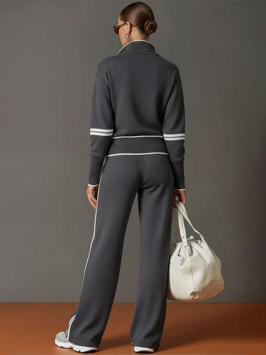 Conjunto de dos piezas negro visto de espaldas: jersey con cremallera y pantalón ancho