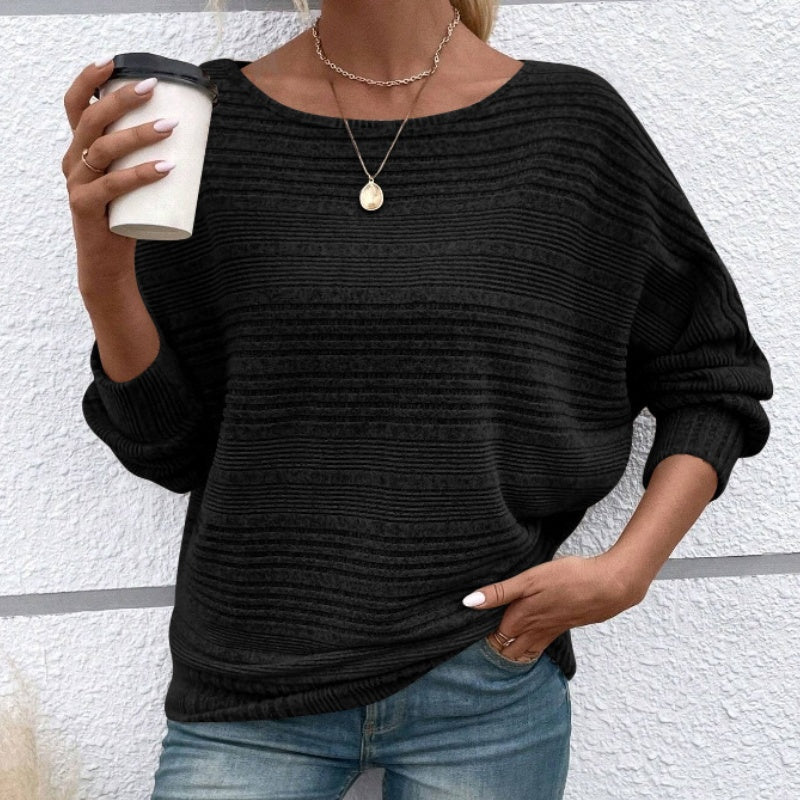 Jersey de punto rayado negro, cuello redondo y mangas largas