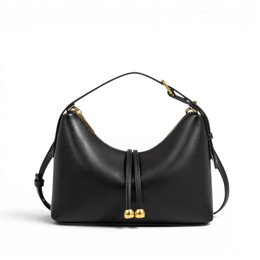 Bolso hobo de piel lisa negro con asa corta y cierre decorativo dorado.