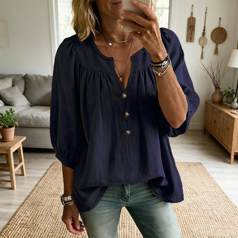 Blusa de mujer azul marino con cuello V, botones al frente y mangas globo abullonadas